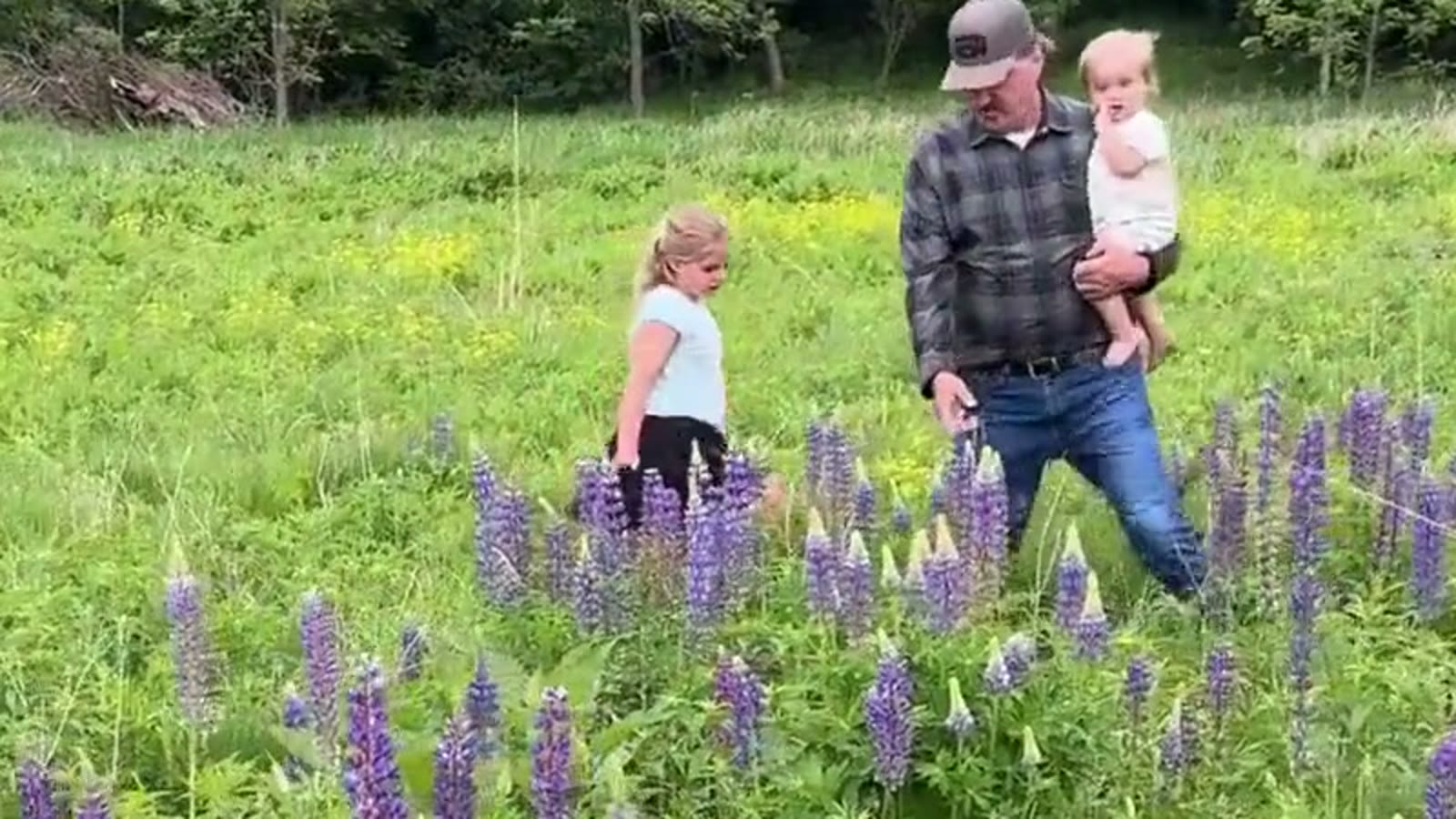 Jon Aleckson walking with his grandchildren in a Wisconsin prairie